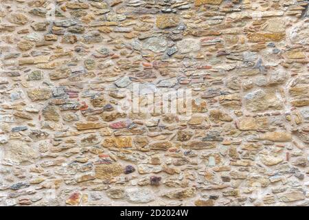 Yellow stones and bricks wall. Vintage background. Closeup stones and bricks wall for designer, architect or builder Stock Photo