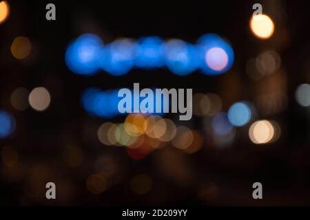 Blurry photo of street at night in city downtown decorated with beautiful Christmas lights decoration. Winter holidays vacation and travel in Europe Stock Photo