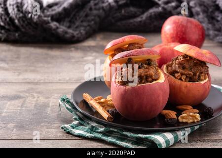 Stuffed apples baked with nuts isolated on wooden table Stock Photo