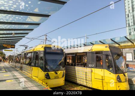 Trams at the Deansgate-Castlefield tram stop on Greater Manchester's Metrolink light rail system in Manchester, UK. Stock Photo