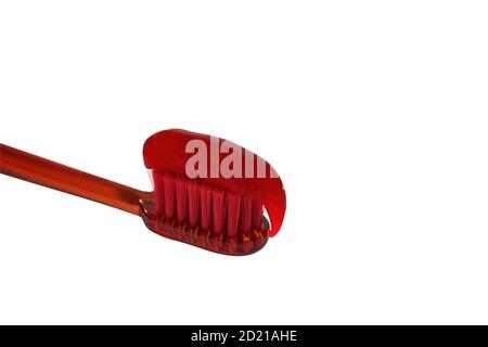 Red toothbrush with red toothpaste isolate on a white background close-up. Stock Photo