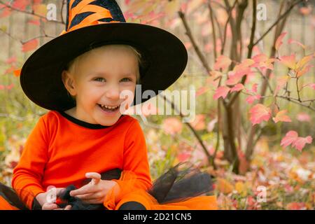 halloween concept - girl dressed as witch outside Stock Photo