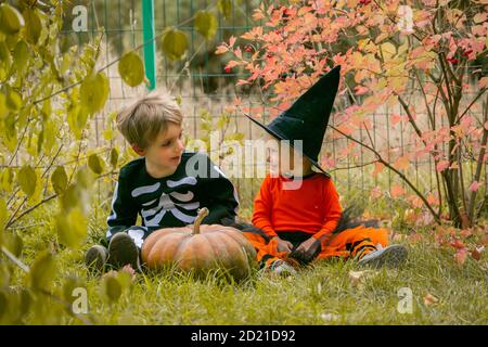 Halloween concept - boy and girl in the fall garden Stock Photo