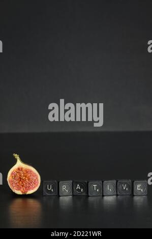 Idea Figurative made from Figs and Scrabble Tile Word on black table Stock Photo