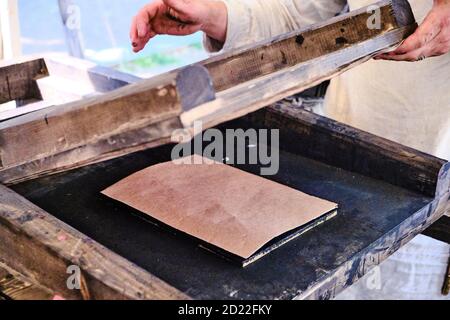 Printing book in a vintage way. Wooden retro typography mechanism for printing. Retro typographical press. Stock Photo