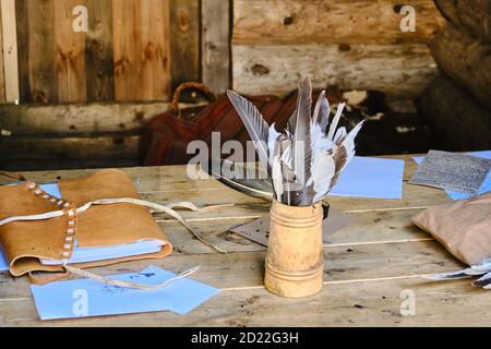 Feathers and ink for writing in retro style. Vintage letter writing set. Stock Photo