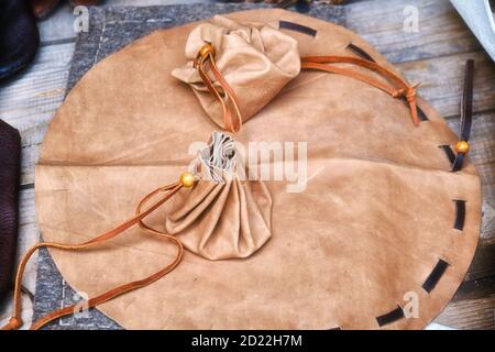 Simple retro leather bag like in the old days. Vintage wallet with ties for coins and money. Stock Photo