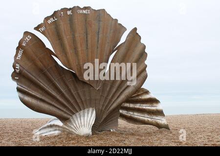 Aldeburgh Suffolk East Anglia England - March 21 2018: Artist Maggie Hambling sea shell scallop bronze sculpture beach on white sand shore by ocean