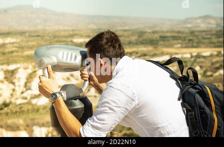 Man looking through horizontally outdoor viewer at lookout in Turkey Stock Photo
