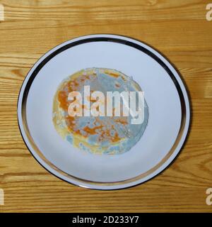 Moldy bread on the white plate Stock Photo