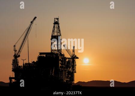 Construction of a new oil platform during sunset Stock Photo