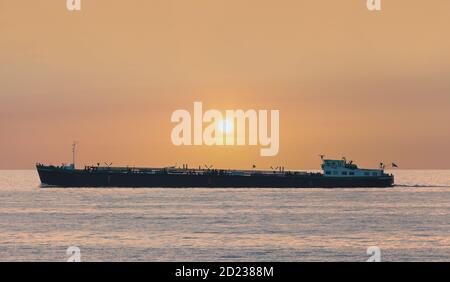 Freight ship passing The Markermeer lake in Holland during sunset Stock Photo