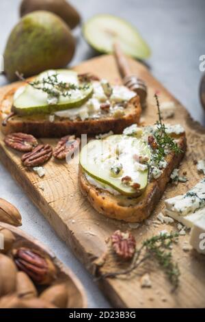 Pear, blue cheese, thyme sandwiches - delicious breakfast, snack, top view Stock Photo