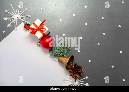 2021 New Year Christmas decorations flatlay. Gift box red ball spruce branch pinecone bell snowflakes in row top view Stock Photo
