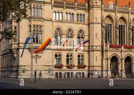 German and Lower Saxonian flags hoisted in front of Braunschweig town hall to celebrate the German unification 30 years earlier. Stock Photo