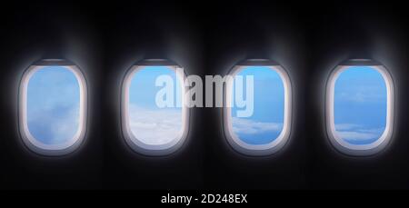 four airplane windows open white window shutter wide with blue sky view. plane portholes usable for banners, brochures in tourism theme. air traveling Stock Photo