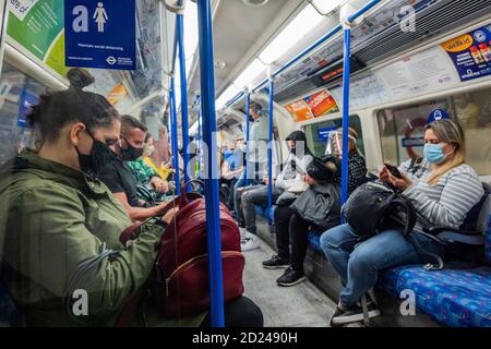 London, UK. 06th Oct, 2020. Passenger numbers remain down on the tube, but are now rising and trains are moderately busy, particularly in the rush hour. Just as the government begins to tighten its Coronavirus (covid 19) guidance again. Those who do travel mostly wear masks after they become mandatory on public transport. Credit: Guy Bell/Alamy Live News Stock Photo