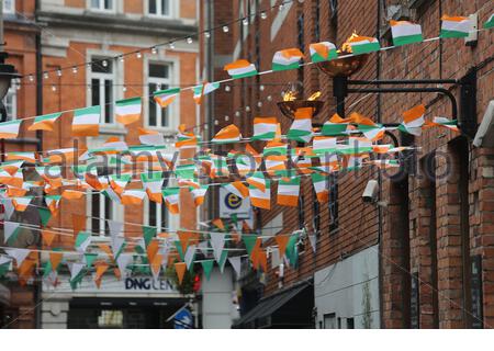 Irish tricolour bunting hanging over a back street in downtown Dublin Stock Photo