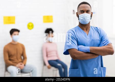Confident African American Doctor In Medical Mask Standing In Hospital Stock Photo