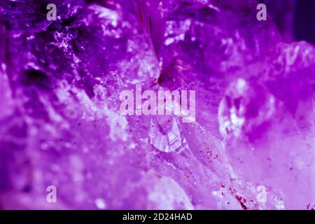 Purple texture background with rough grunge surface. Strong lilac or lavender colors with faded stone or rock design. Stock Photo