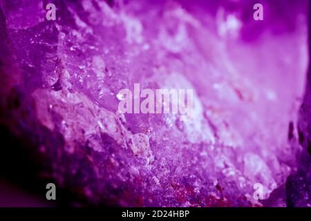 Purple texture background with rough grunge surface. Strong lilac or lavender colors with faded stone or rock design. Stock Photo