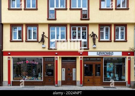 Wernigerode is full of architectural details. Opticians store entrance has metal statues on top with people wearing glasses and hearing aid. Stock Photo