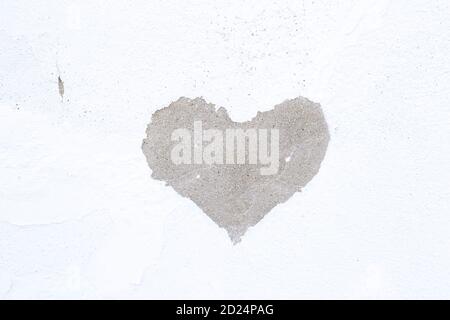 White wall painted and chipped with the shape of a heart Stock Photo