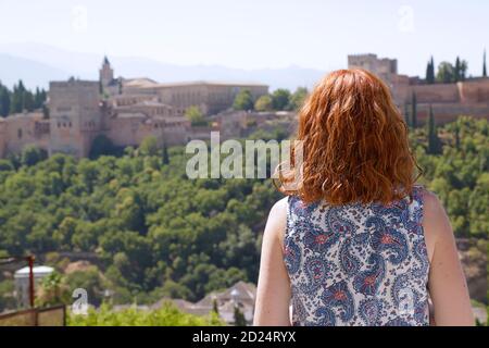Woman enjoying the view of the Alhambra the ancient arabic fortress located in Granada, Spain Stock Photo