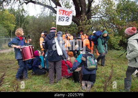 Warwickshire, UK. 05th Oct, 2020. HS2 protestors break through baricades to draw attention to the destruction of a 250 year old, tree of the year 2015, the Cubbington Pear tree 05 Oct 2020. As protestors approach the tree they are met with extreme force from HS2 security guards in order to prevent them from hugging the tree Credit: Denise Laura Baker/Alamy Live News Stock Photo