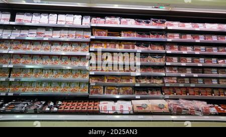 Meat, Supermarket, Butcher. Packets Of Meat At The Supermarket. Meat Aisle In Supermarket. Packaged Meats In Supermarket Refrigerated Section. Bacon, Stock Photo