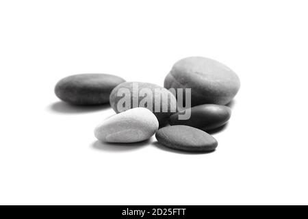 Scattered sea pebbles. Group of smooth gray and black stones isolated on white background Stock Photo