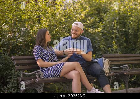 Happy young couple enjoys spring day in park. Holding hands. Stock Photo
