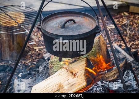 Cauldron or camping kettle over open fire outdoors Stock Photo - Alamy