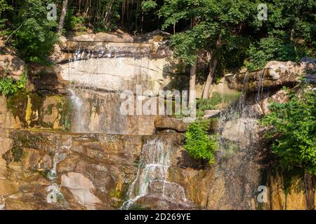 Water flowing down the rocks on a sunny summer day Stock Photo