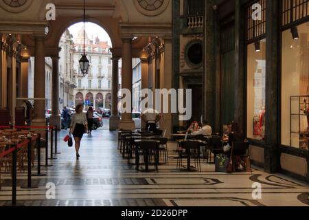 Turin, Italy - september 2020: a Caucasian woman goes shopping under the arcades of the San Federico gallery Stock Photo