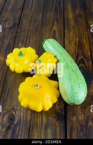 Zucchini and  mini patty pan squashes on dark wooden table. Harvest vegetables. Stock Photo