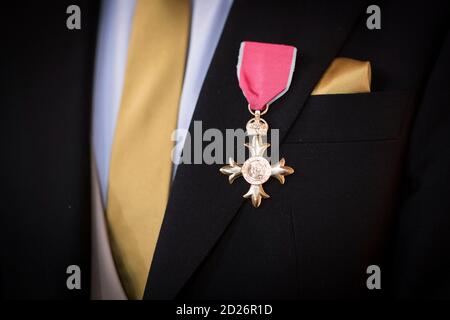 Member of British Empire Cross on a suit lapel Stock Photo