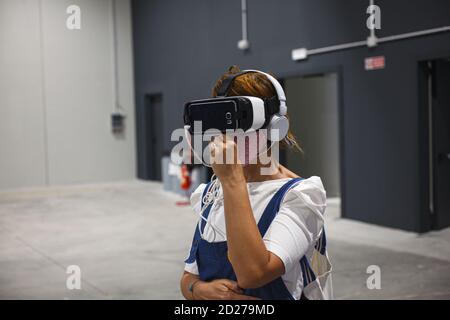 Trieste, Italy - September, 06: Woman wearing virtual reality headset during the ESOF, Euroscience open forum in Trieste on September 06, 2020 Stock Photo