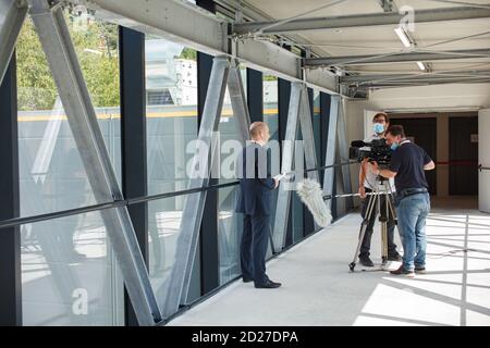 Trieste, Italy - September, 06: A correspondent with his television troupe during the news broadcasting at the ESOF, Euroscience open forum in Trieste Stock Photo