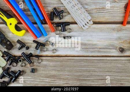 Various set of tools for the plumber on preparing master before work, polypropylene pipes, corners, fasteners, pipe cutting tools, fixings Stock Photo