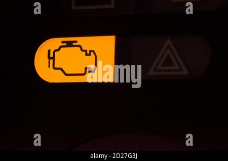 Warning sign of a car engine, orange engine sign on a panel of car ...