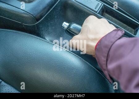 close up of a man's hand holding the handbrake in a car Stock Photo