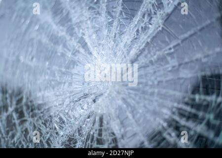 broken car windshield with a hole in the center of the image. background, texture Stock Photo