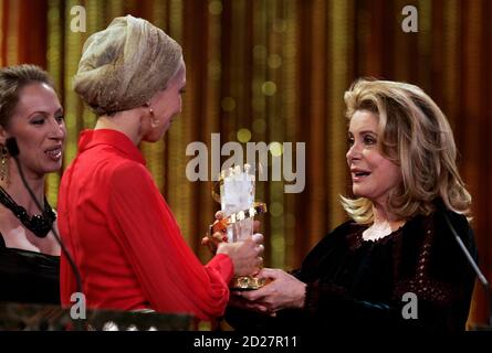 Estonian film producer Katrin Kissa (C) and Estonian actress Tina Tauraite  (L) receive The Golden Star award from French actress Catherine Deneuve  during the closing ceremony of the 7th Marrakesh International Film