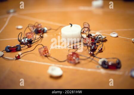 on the floor painted pentagram, candles, beads lie scattered shells. concept of magic with occult and esoteric symbols. Stock Photo