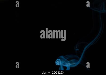 Beautiful abstract blue smoke with copy space on black background. Smoke background for art design or drawing. Abstract figure of the smoke Stock Photo