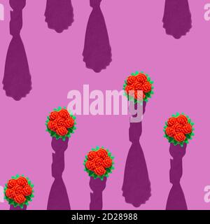 Photo in the form of a seamless pattern. Red flowers in a yellow bouquet are arranged vertically with shadows on a colored pink background. High quality photo Stock Photo