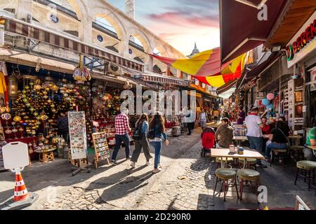 Local Turks walk through the narrow alleys and cobbled streets of the Eminonu Market in Istanbul Stock Photo
