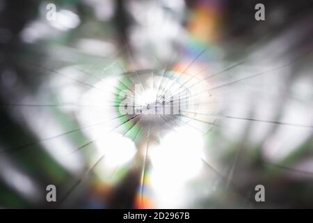abstract background of broken tft lcd with localized radial cracks from one hit - close-up with selective focus and blur Stock Photo