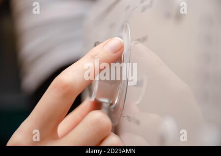 woman's hand adjusts the settings on the washing machine's control panel using a wheel Stock Photo